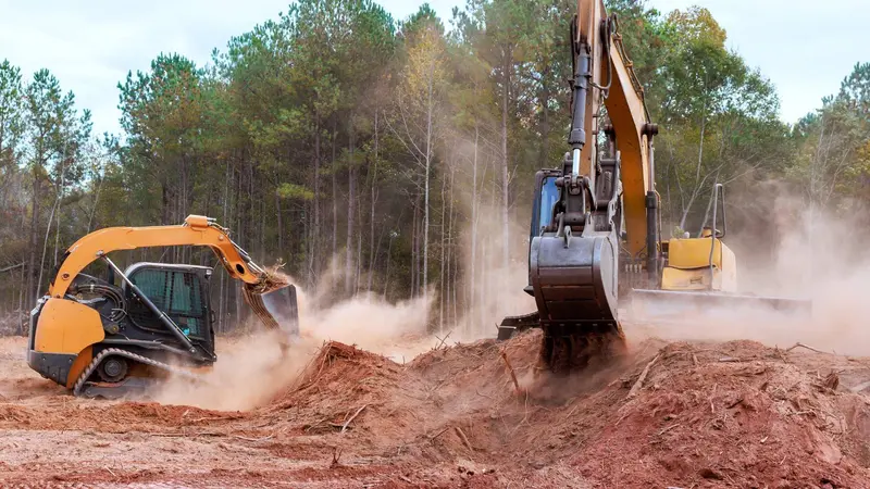 Excavator and loader clearing wooded lot in Fox Valley area